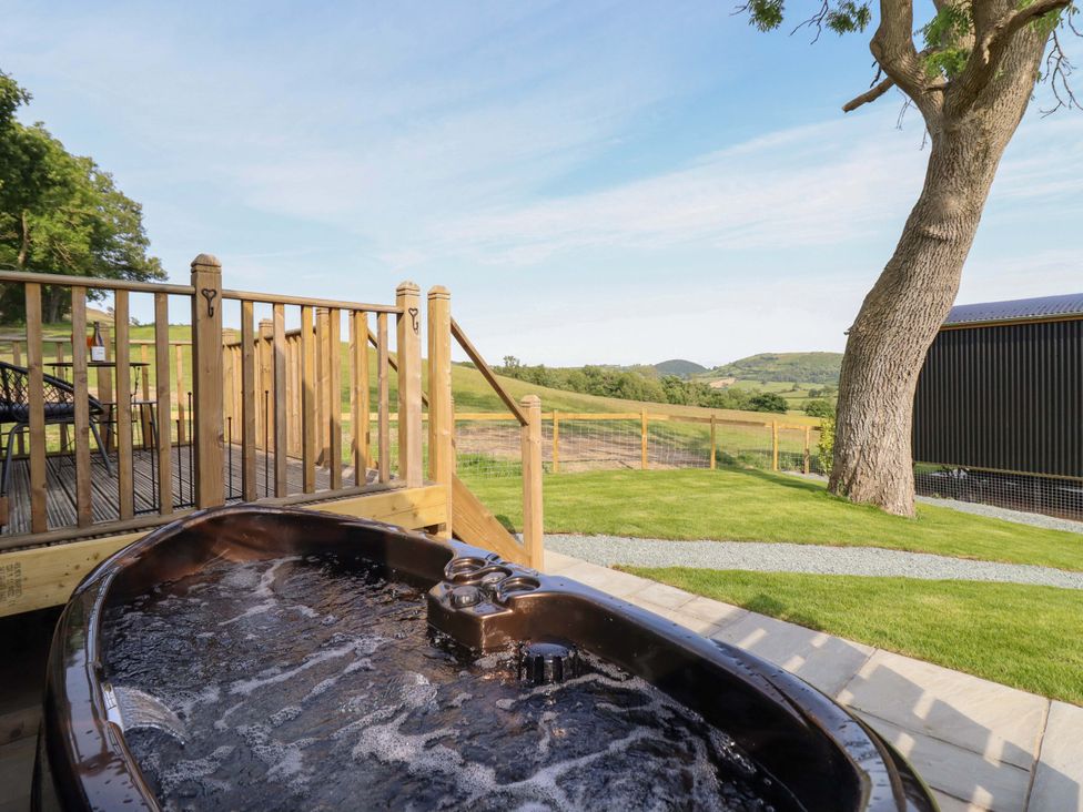 An outdoor area with a hot tub and decking at Cheviot in Oswestry