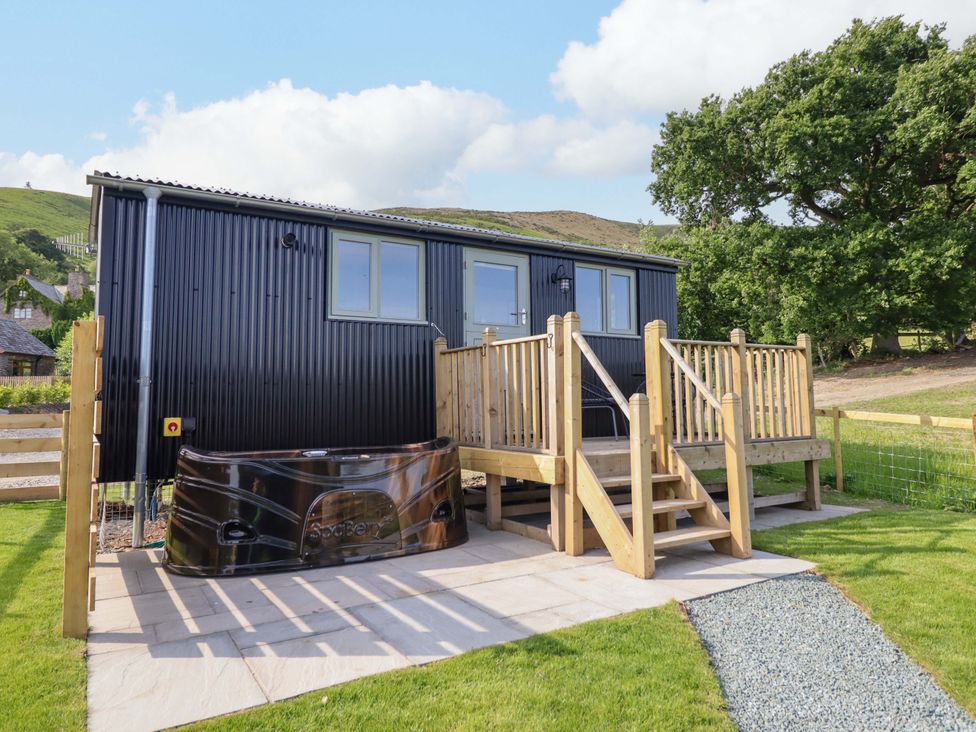 An outdoor area with a hot tub and decking at Cheviot in Oswestry