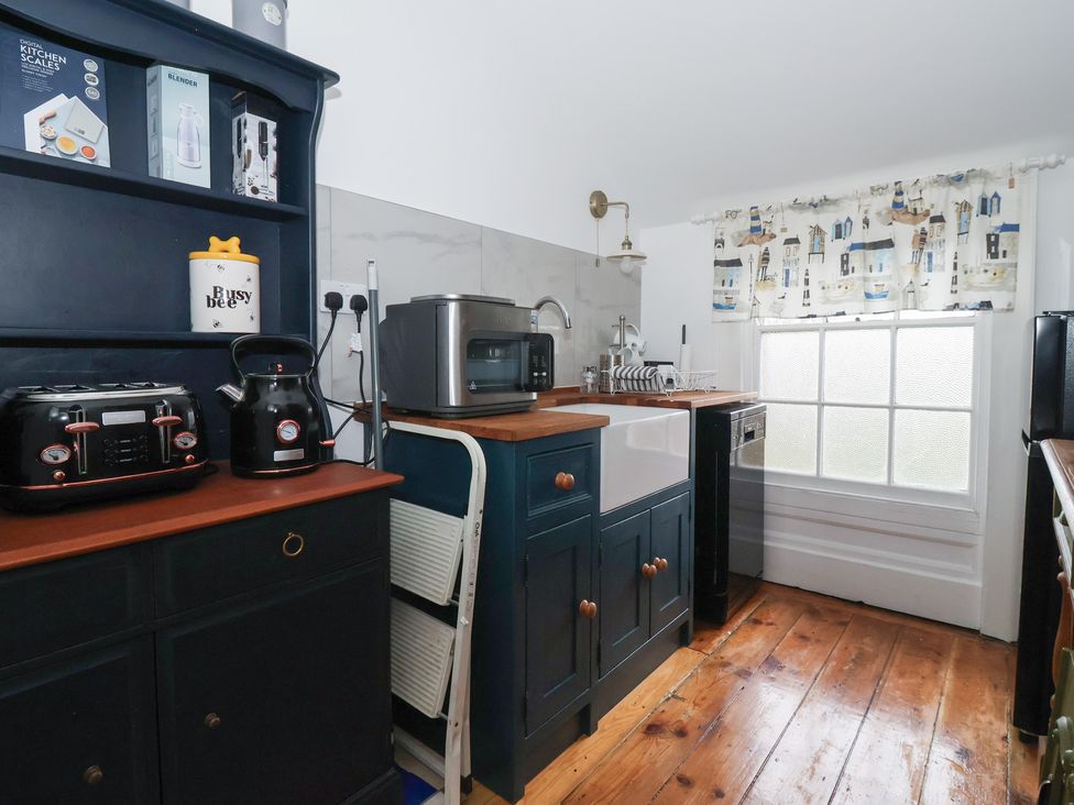 A kitchen with appliances and a window at Elstronwick Hall Apartment 