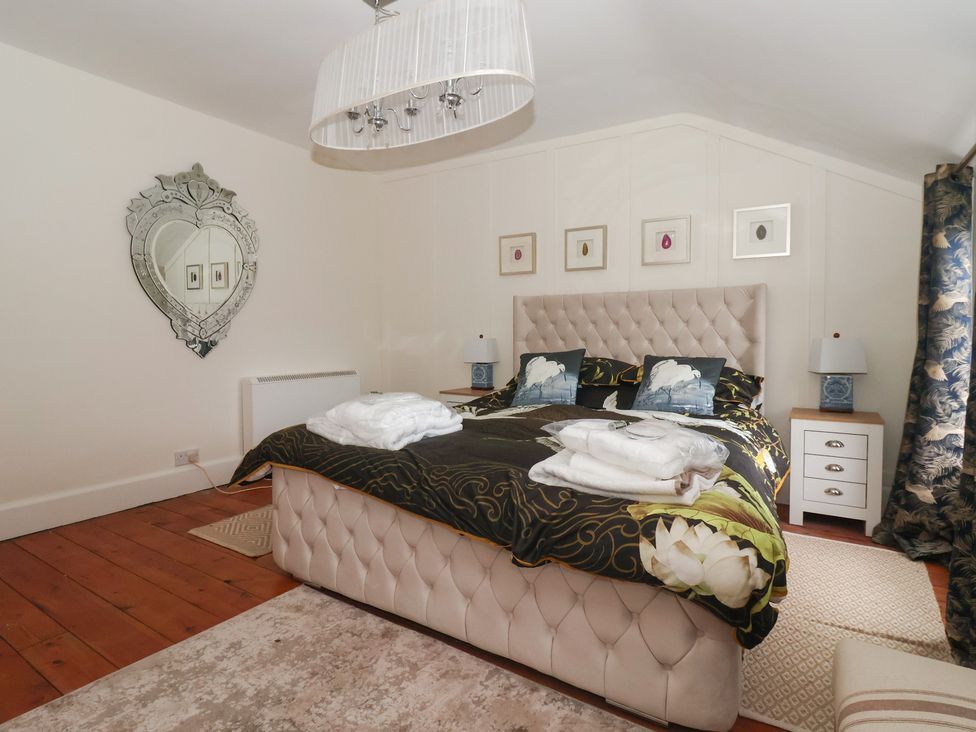 A bedroom with a bed and nightstands at Elstronwick Hall Apartment