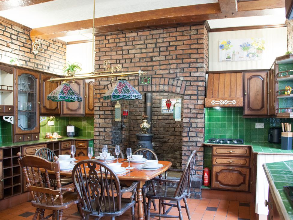 A kitchen with a dining table and chairs at 4 Kingscliffe Street in Manchester