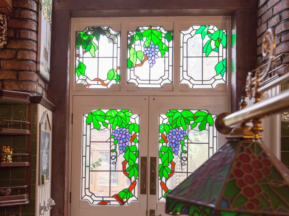 A stained glass door with grape designs at 4 Kingscliffe Street Manchester