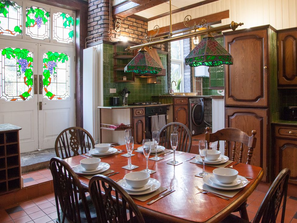 A kitchen with a dining table set for dinner at 4 Kingscliffe Street in Manchester