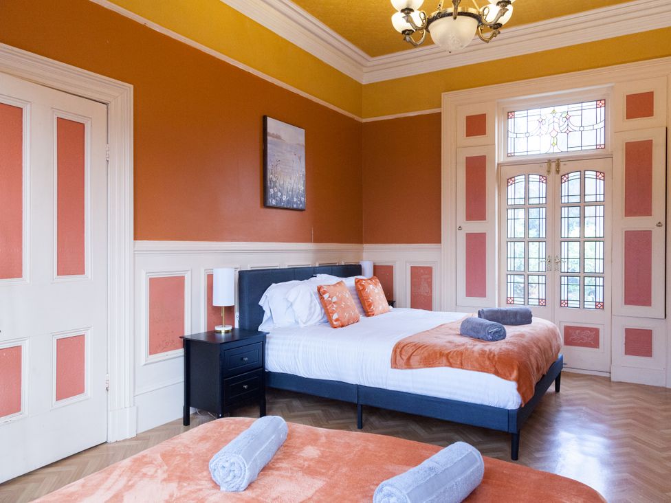 A bedroom with a bed and windows at 4 Kingscliffe Street in Manchester