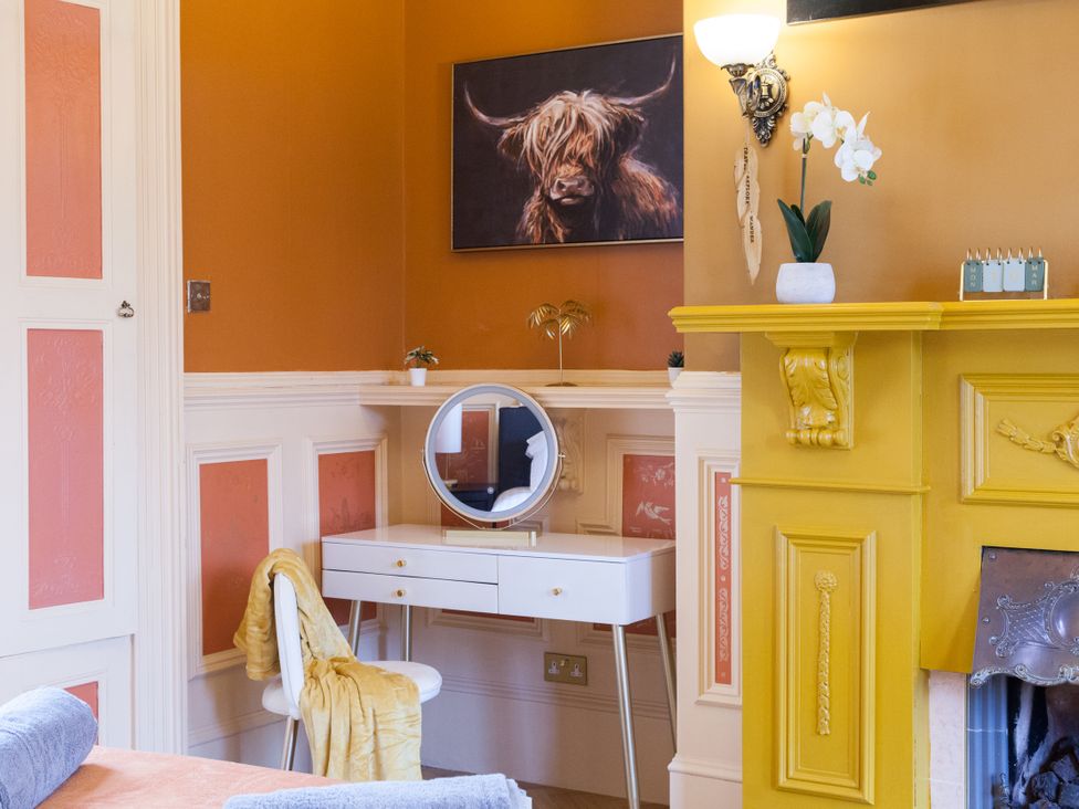 A bedroom with a mirror and vanity table at 4 Kingscliffe Street Manchester