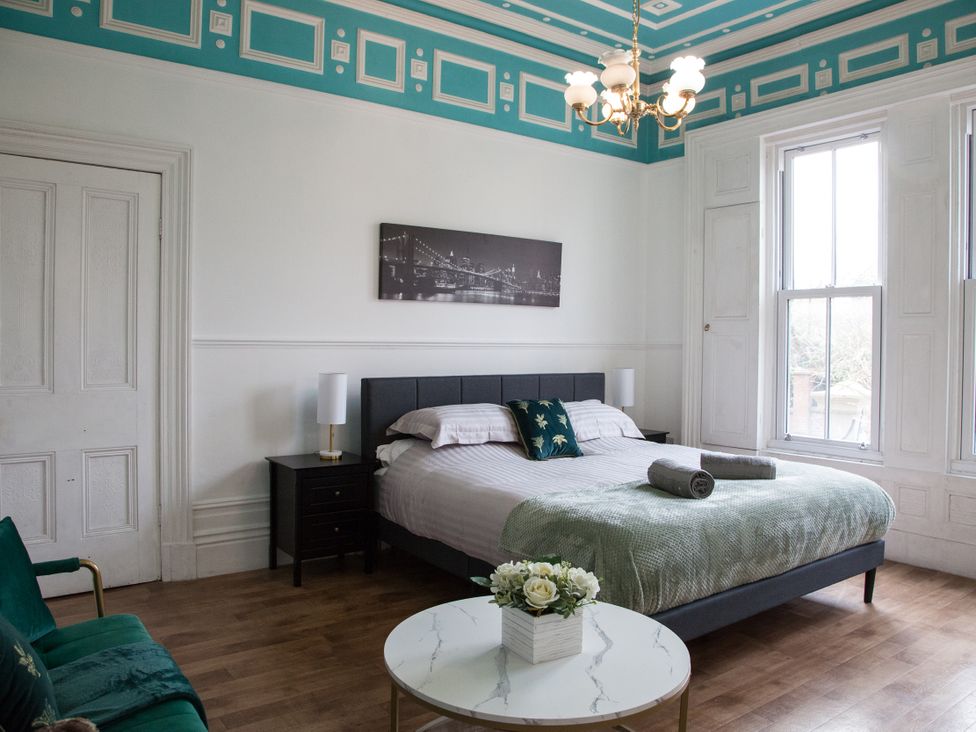 A bedroom with a bed and a nightstand at 4 Kingscliffe Street in Manchester