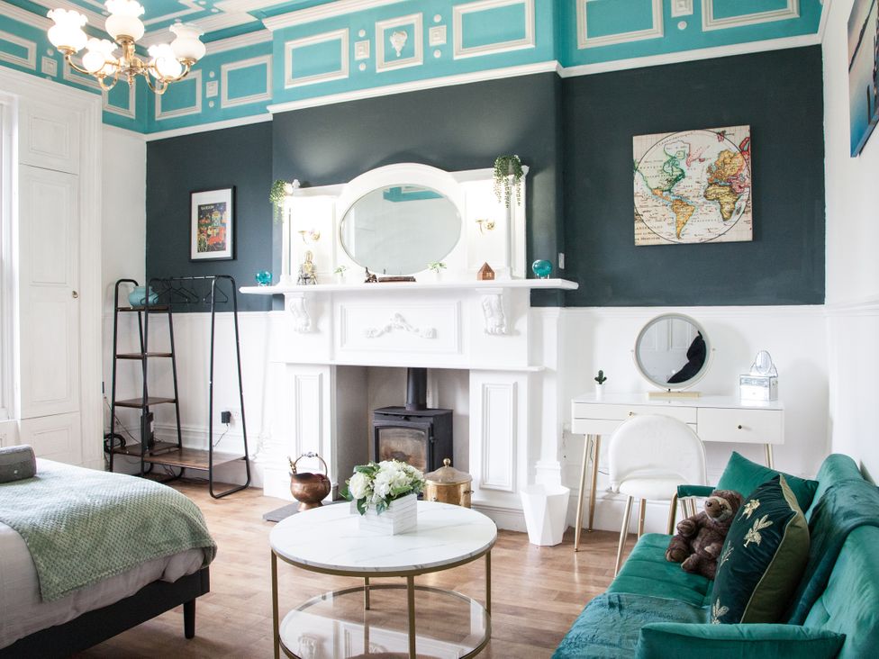 A living room with a sofa and table at 4 Kingscliffe Street in Manchester