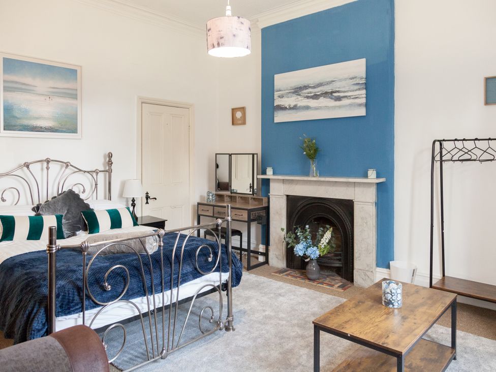 A bedroom with a bed and fireplace at 4 Kingscliffe Street in Manchester