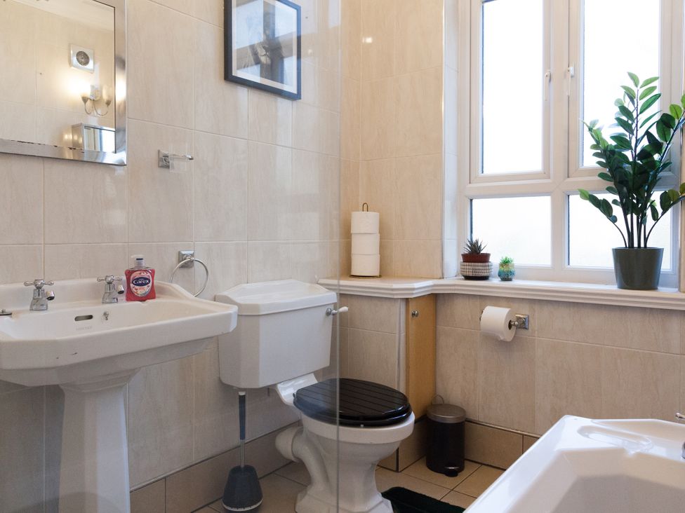 A bathroom with a sink and toilet at 4 Kingscliffe Street in Manchester