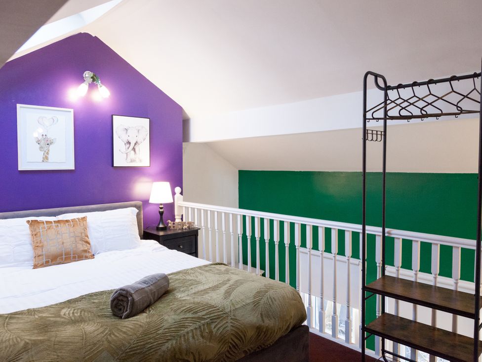 A bedroom with a bed and artwork on wall at 4 Kingscliffe Street Manchester