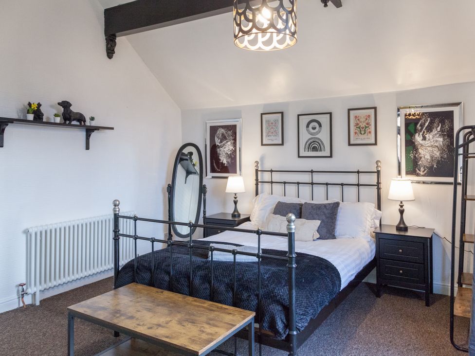 A bedroom with a bed and decorative items at 4 Kingscliffe Street in Manchester