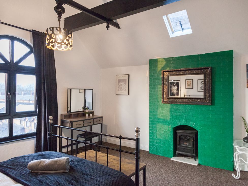 A bedroom with a bed and dresser at 4 Kingscliffe Street in Manchester