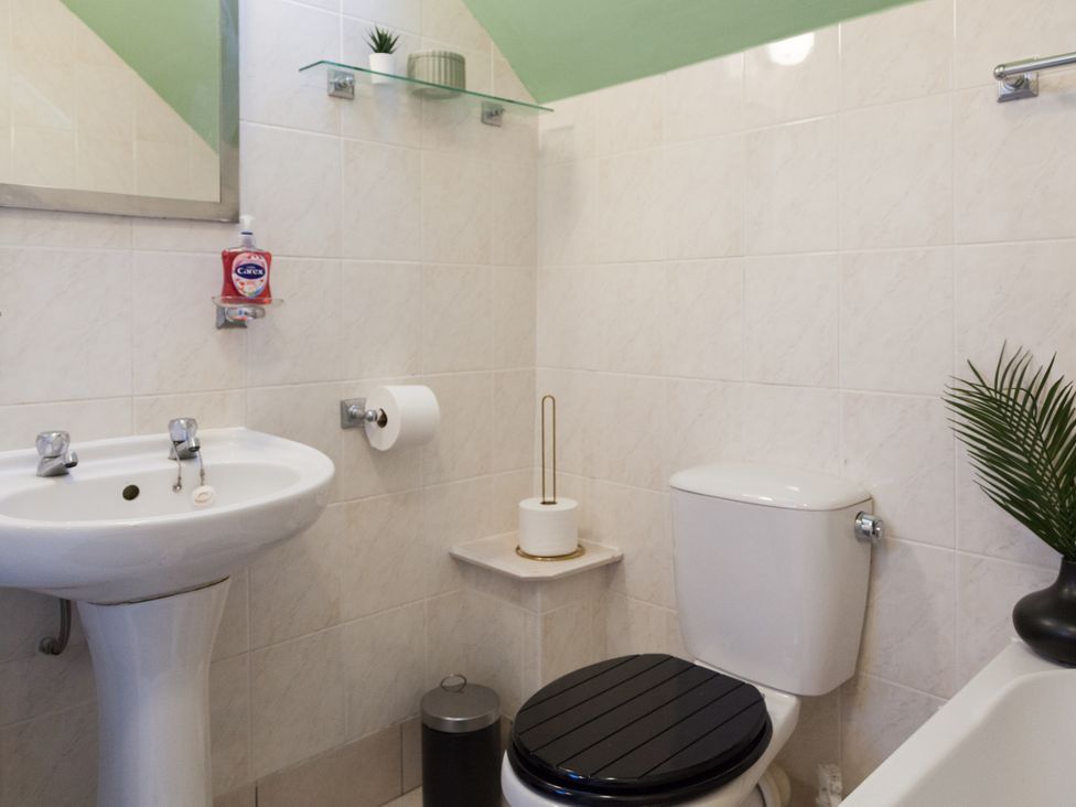 A bathroom with a sink and toilet at 4 Kingscliffe Street in Manchester