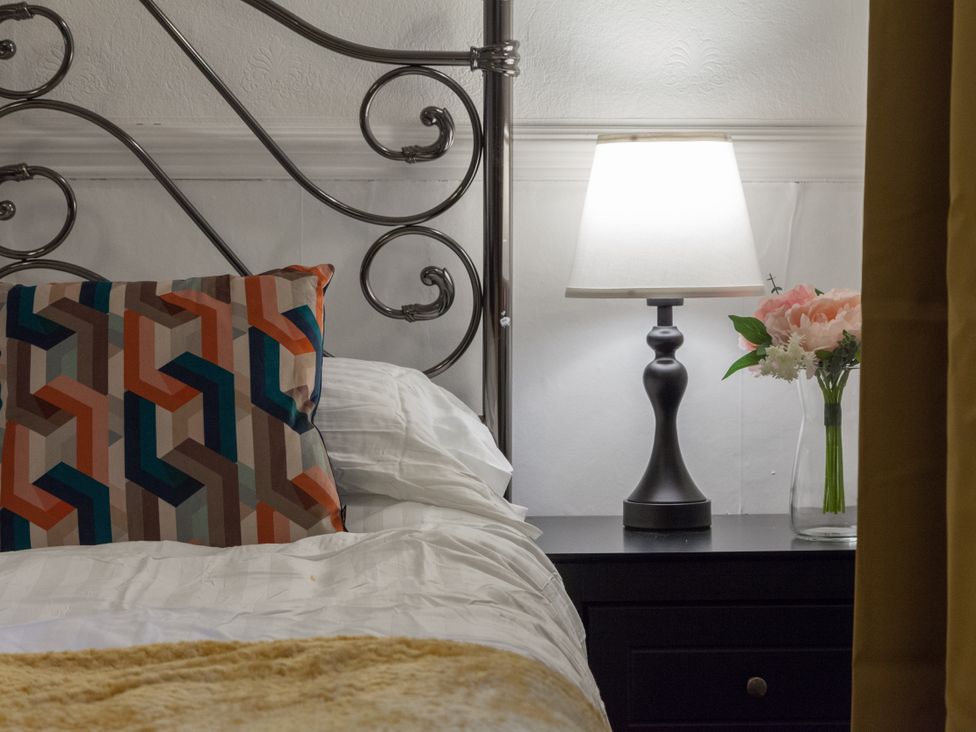 A bedroom with a bed and lamp at 4 Kingscliffe Street in Manchester