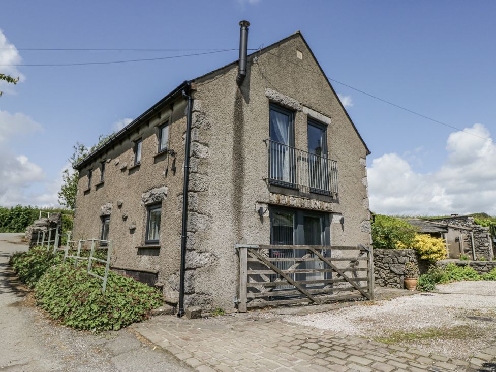 A house with a balcony and driveway at Threagill in Carnforth