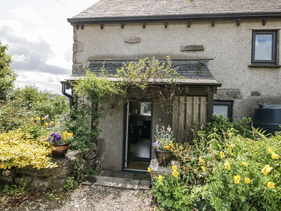 An entryway with plants and flowers at Threagill in Carnforth