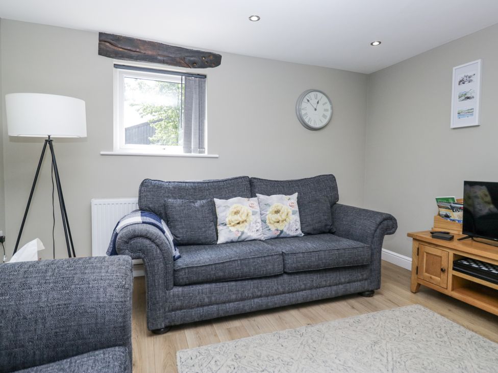 A living room with a sofa and lamp at Threagill in Carnforth
