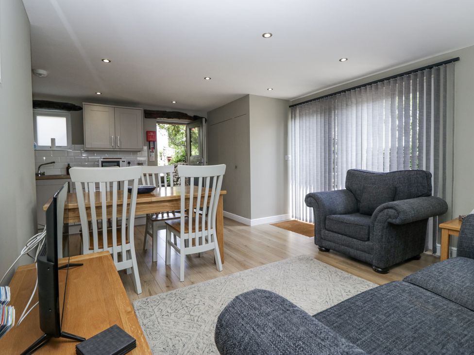 A living room with dining table and sofa at Threagill in Carnforth