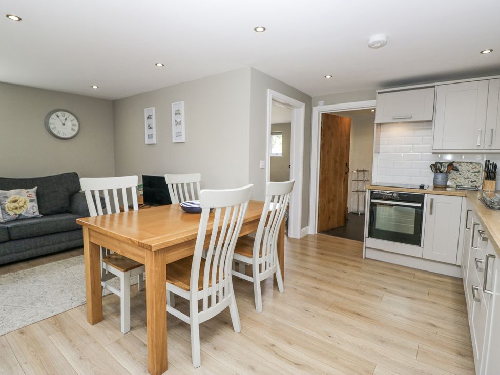 A dining room with a wooden table and chairs at Threagill in Carnforth