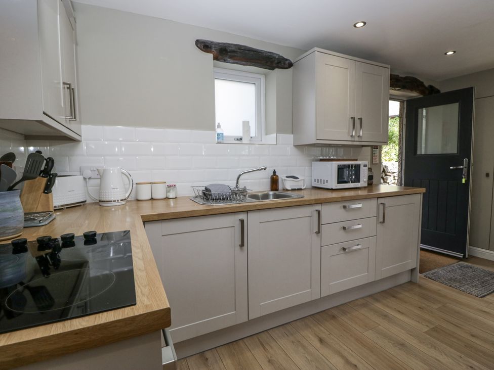 A kitchen with a sink and microwave at Threagill in Carnforth