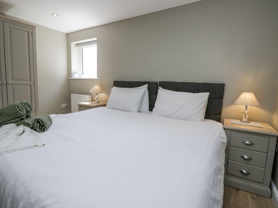 A bedroom with a bed and bedside table at Threagill in Carnforth