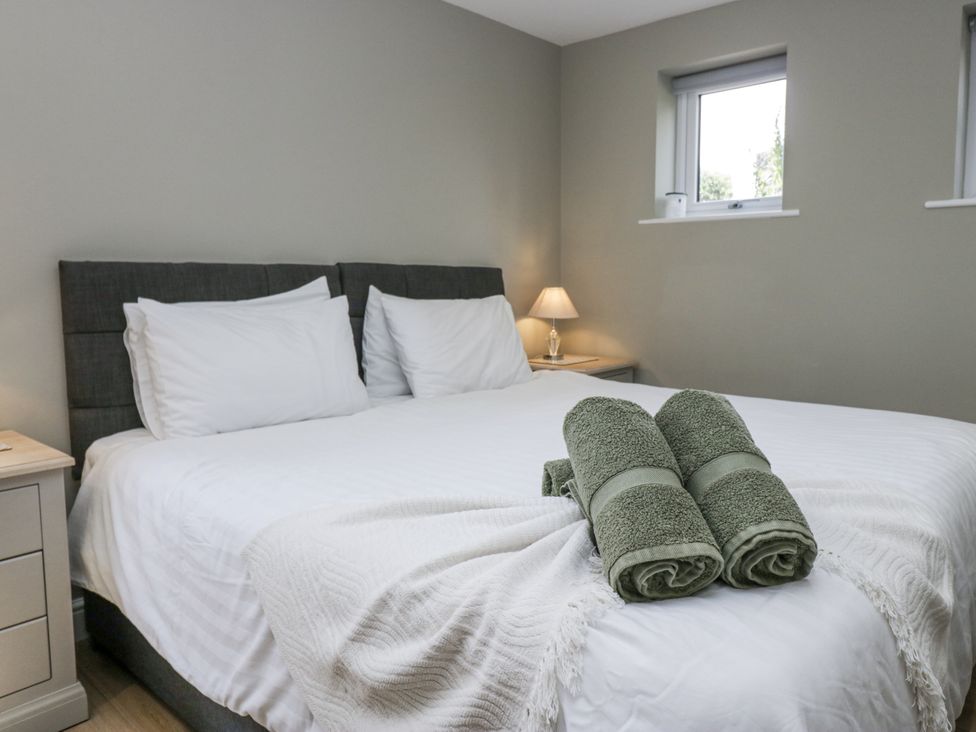 A bedroom with a double bed and towels on it at Threagill in Carnforth