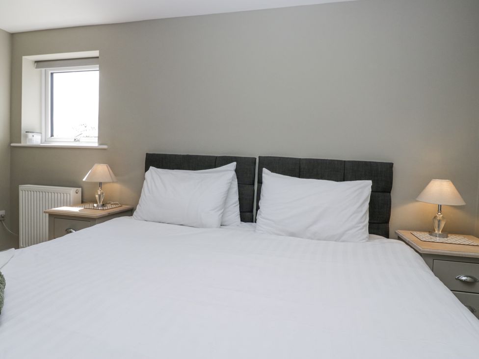 A bedroom with a bed and nightstands at Threagill in Carnforth