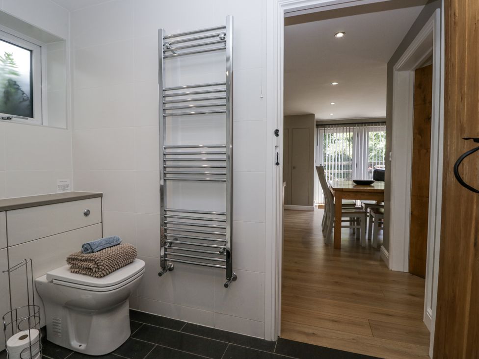 A bathroom with a toilet and towel rack at Threagill in Carnforth