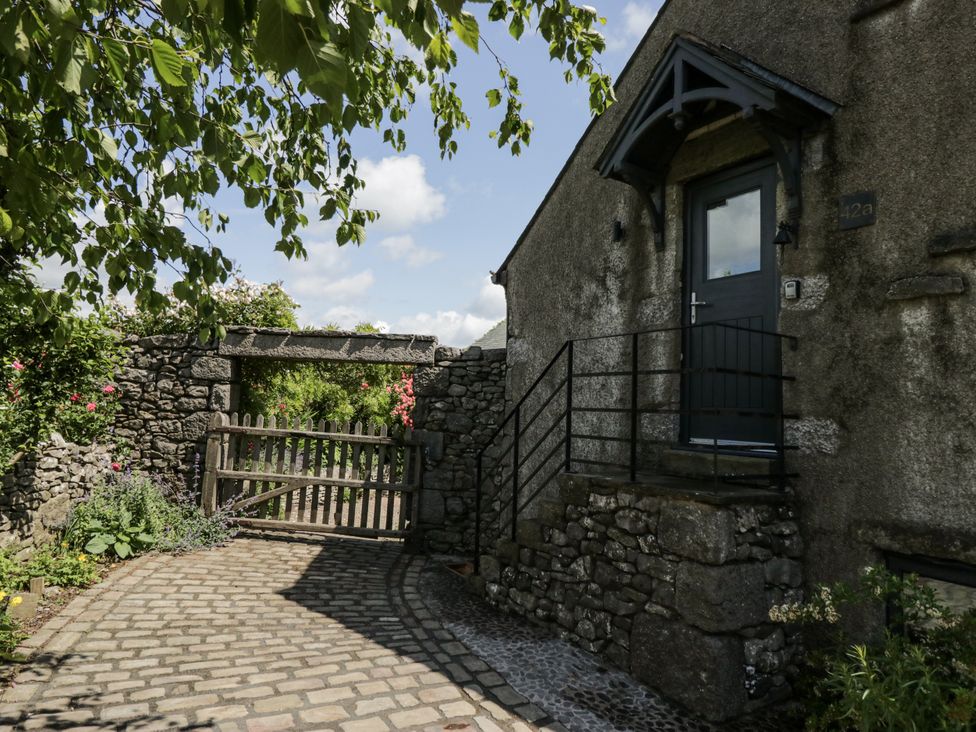 An entrance with a stone pathway and a gate at Treacle in Carnforth