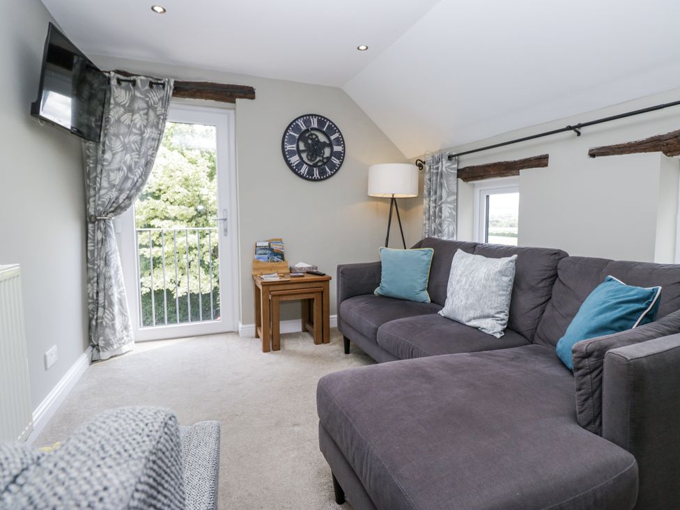 A living room with a sofa and table at Treacle in Carnforth