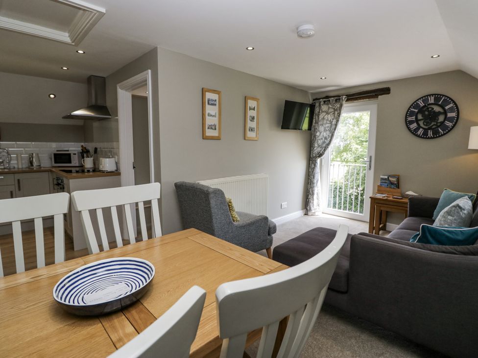 A living room with a dining table and couch at Treacle in Carnforth