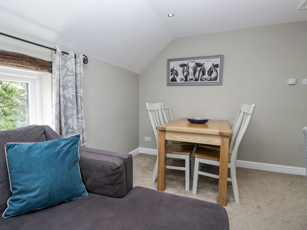A dining room with a table and chairs at Treacle in Carnforth