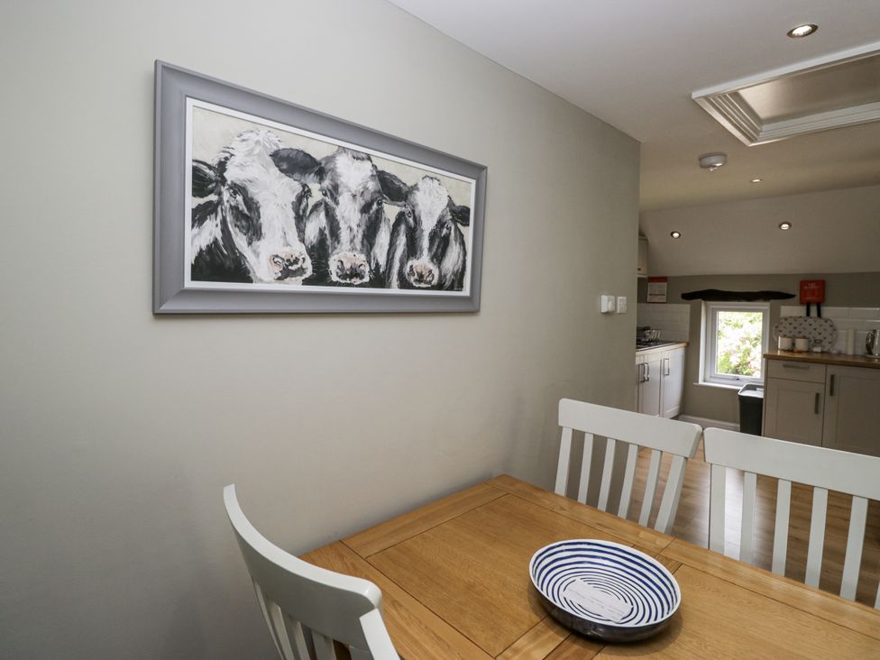 A dining room with a table and chairs at Treacle in Carnforth