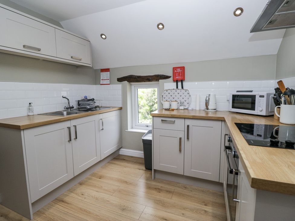 A kitchen with a sink and cooking range at Treacle in Carnforth