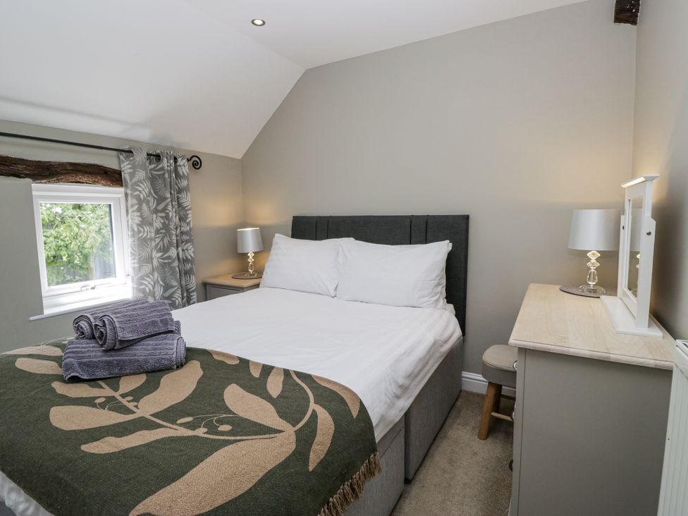 A bedroom with a bed and bedside table at Treacle in Carnforth