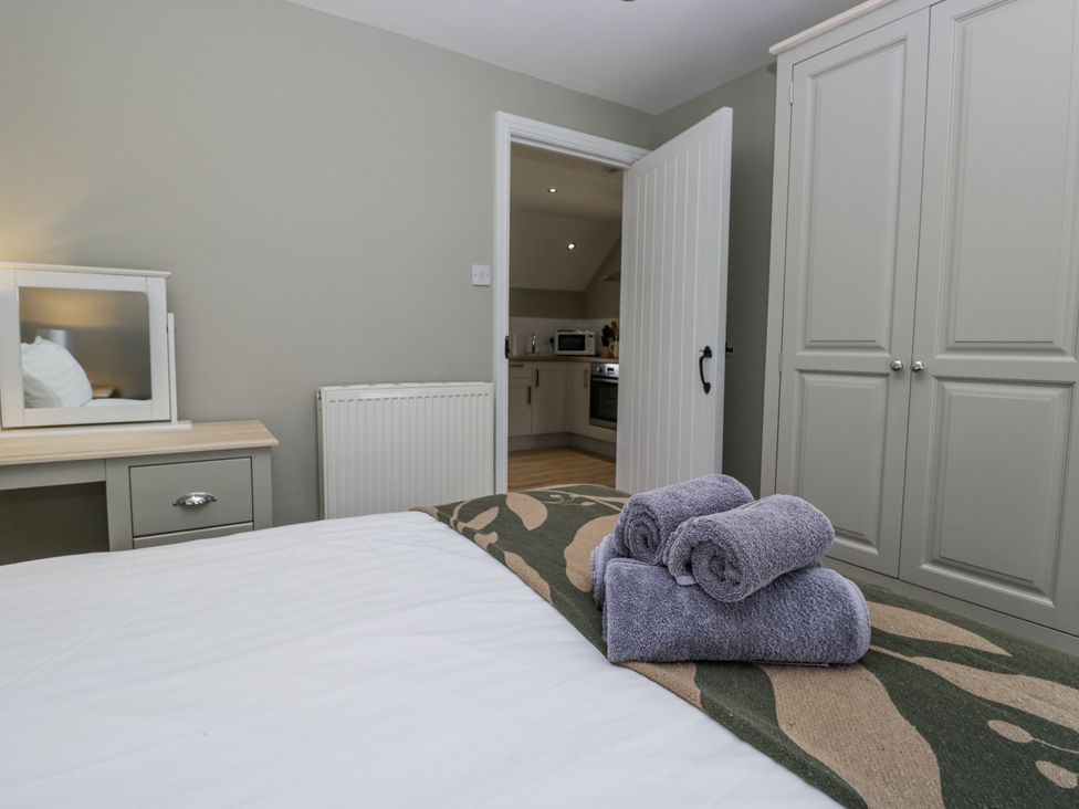 A bedroom with towels on a bed at Treacle in Carnforth