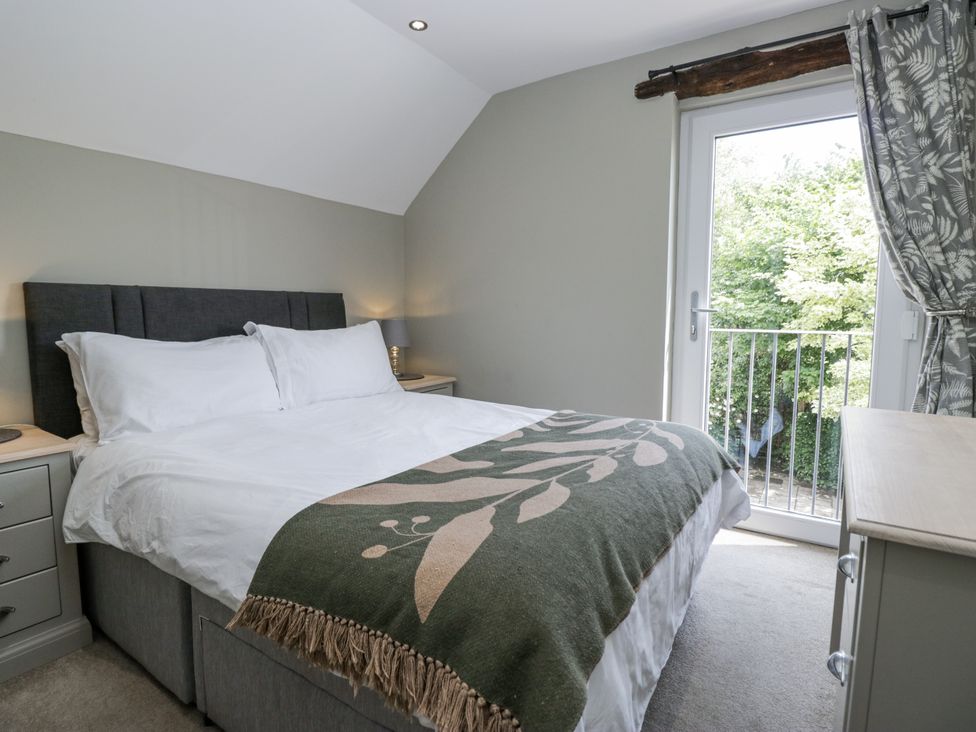 A bedroom with a bed and a window at Treacle in Carnforth