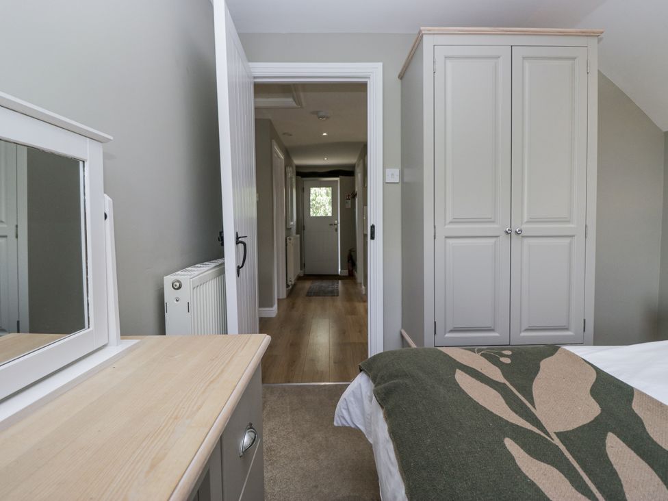 A bedroom with a mirror and wardrobe at Treacle in Carnforth