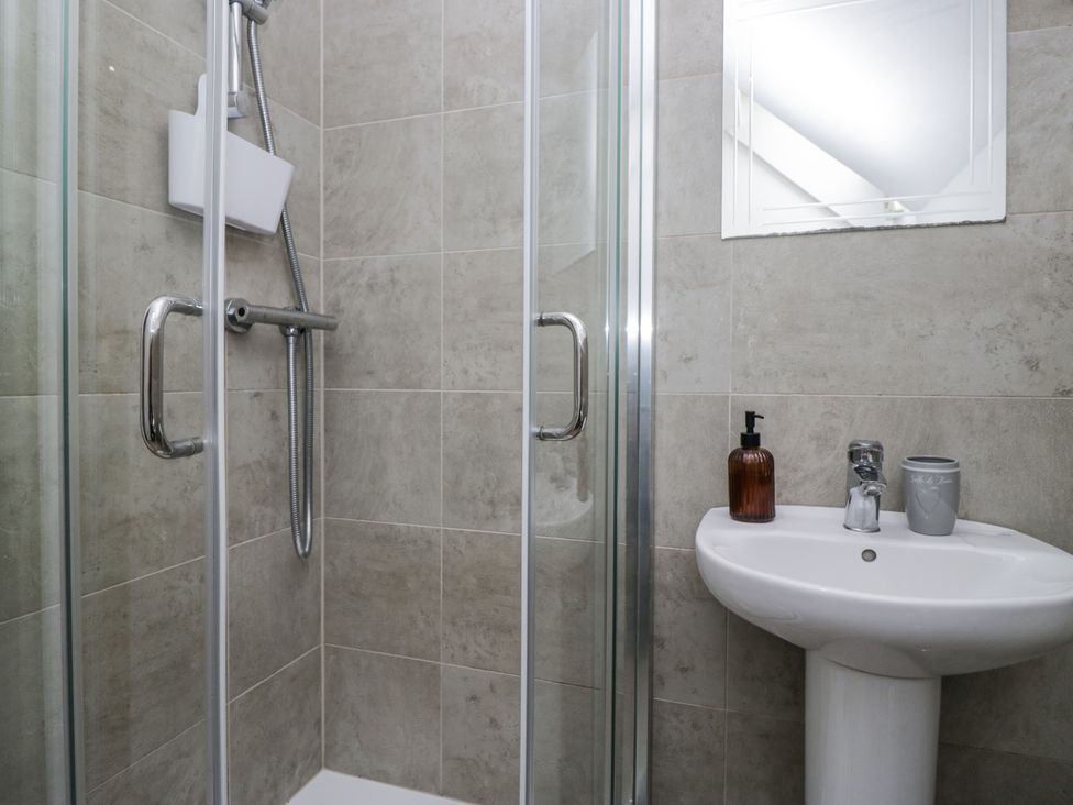 A bathroom with a shower and a wash basin at Treacle in Carnforth