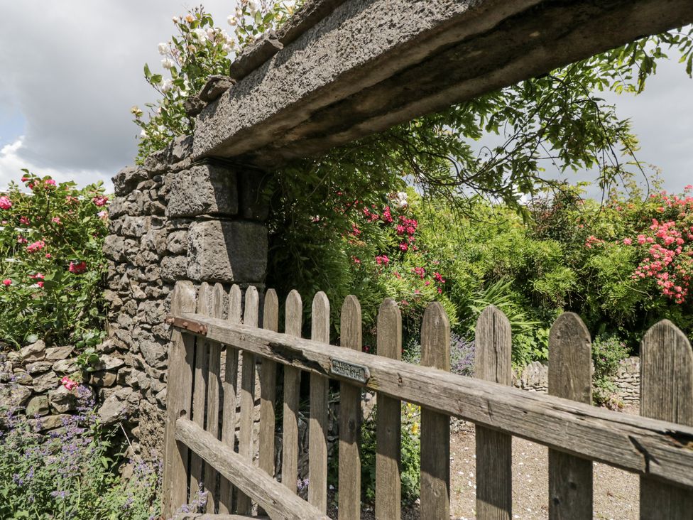 A garden view through a wooden gate at Treacle in Carnforth