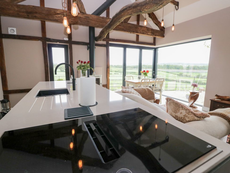 A kitchen with an island and dining area at Lindeth Croft in Carnforth