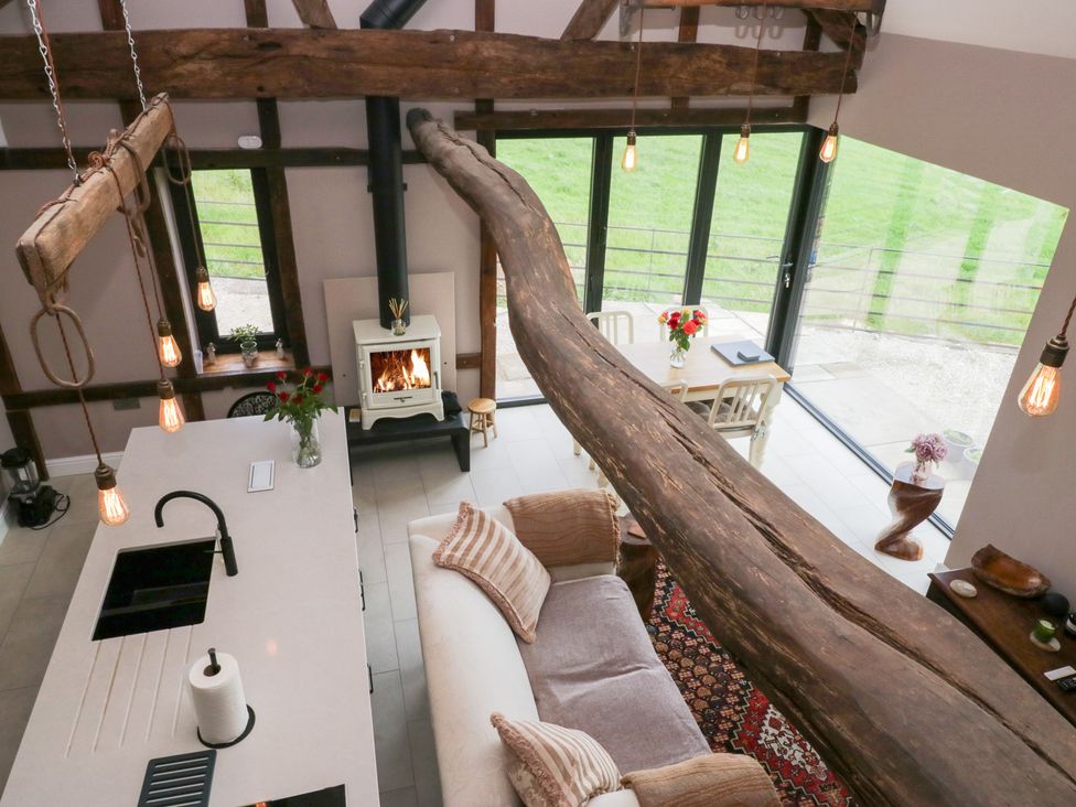 A living room with a kitchen island and dining table at Lindeth Croft in Carnforth