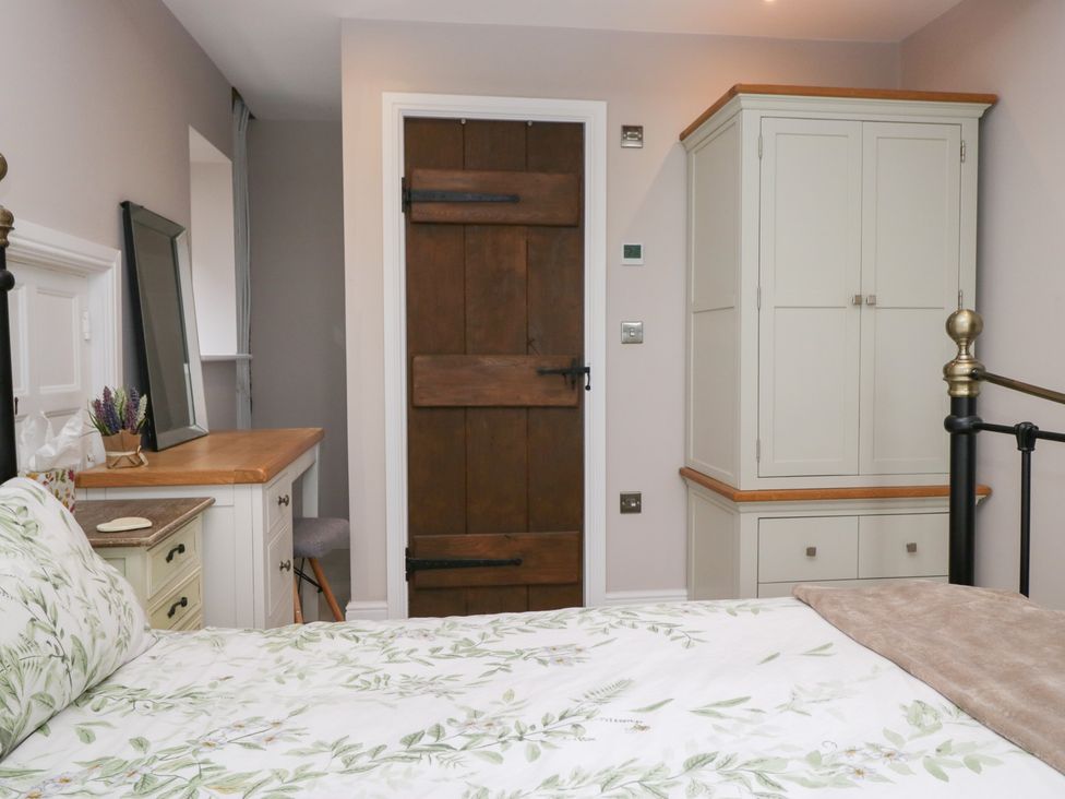 A bedroom with a bed and wardrobe at Lindeth Croft in Carnforth