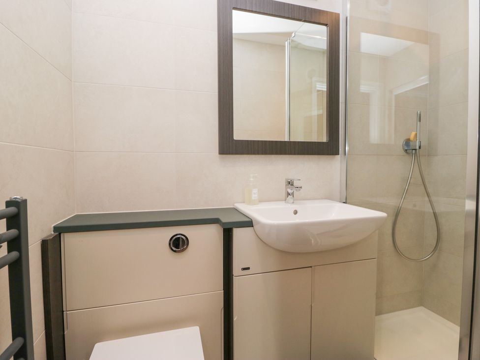 A bathroom with a sink, shower, and toilet at Lindeth Croft in Carnforth