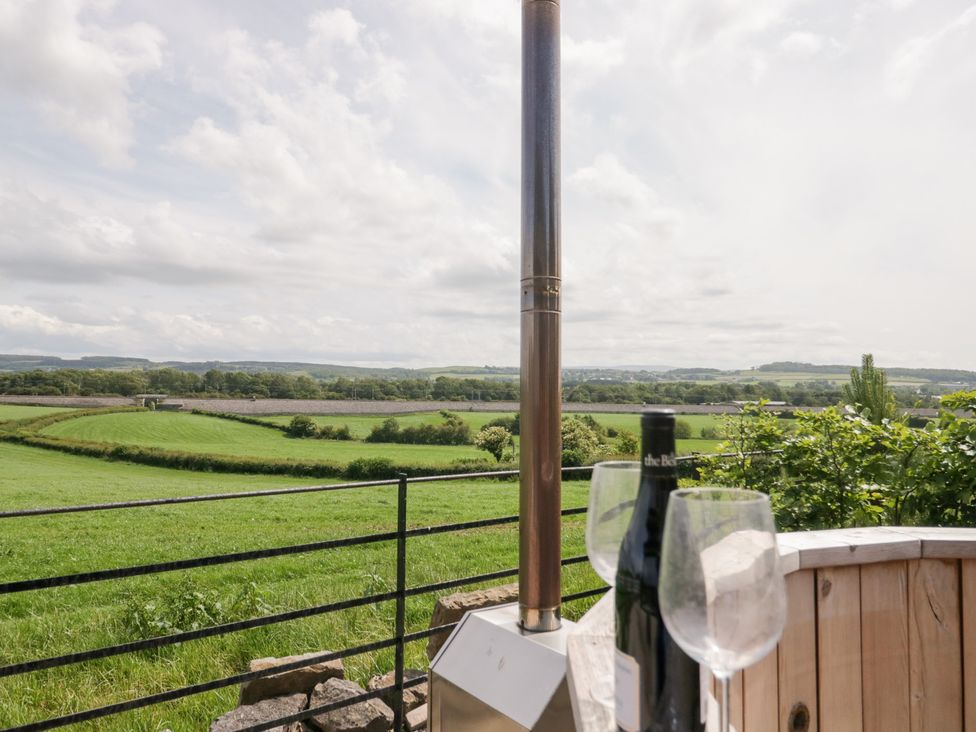 An outdoor view with wine glasses and a bottle at Lindeth Croft in Carnforth