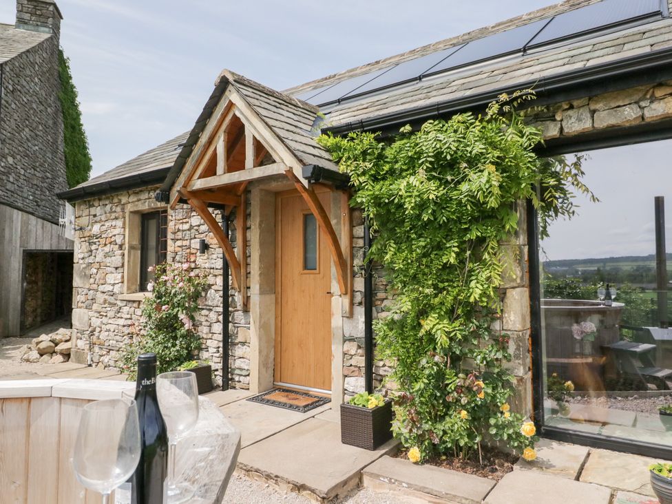 An entrance with a wooden door and greenery at Lindeth Croft in Carnforth