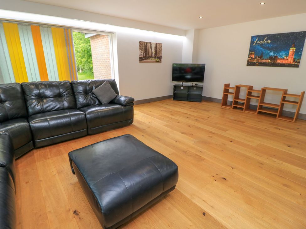A living room with a sofa and television at Silver Copse in Frilford Heath Near Abingdon