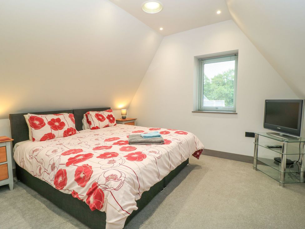A bedroom with a bed and television at Silver Copse Frilford Heath Near Abingdon