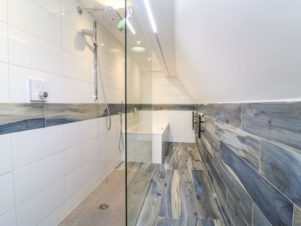 A bathroom with a shower and bath at Silver Copse in Frilford Heath Near Abingdon