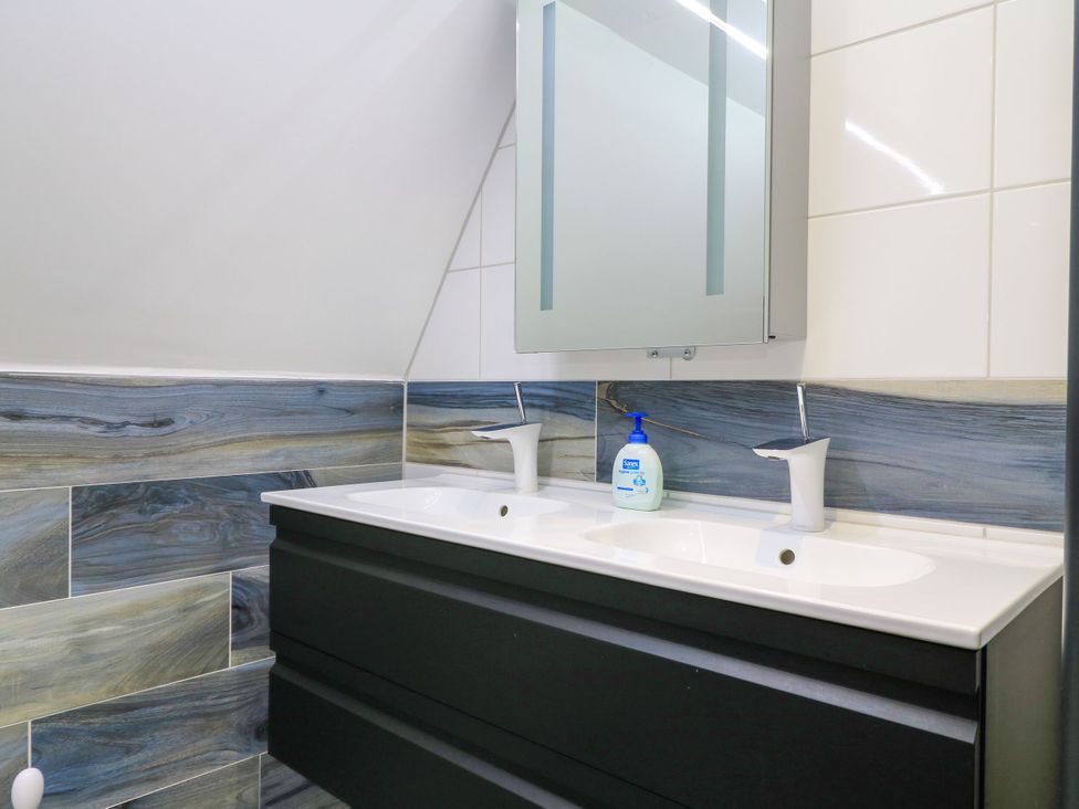 A bathroom with a double sink and mirror at Silver Copse Frilford Heath Near Abingdon